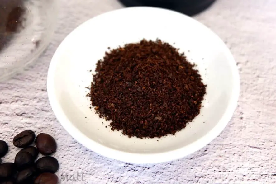 a small bowl with ground coffee.