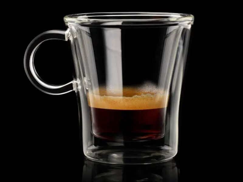 Shot of espresso with crema in a glass
