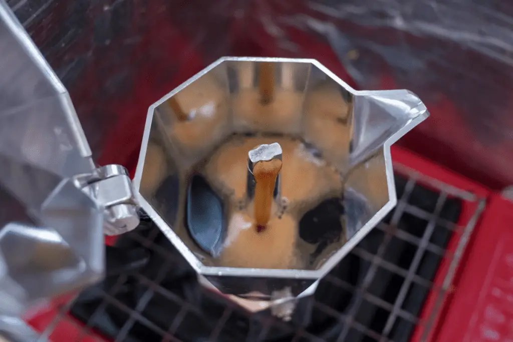Coffee flowing into the collector of a moka pot