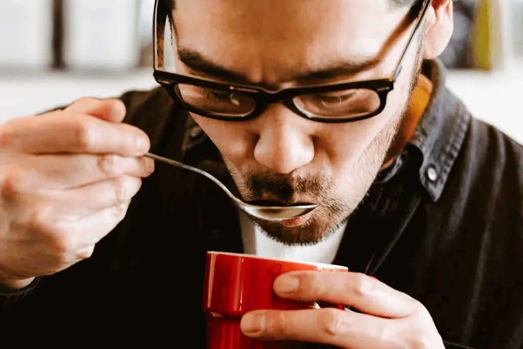 image of a man tasting coffee